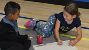 Two young students from West Chester Friends School enjoy doing some drawing together.