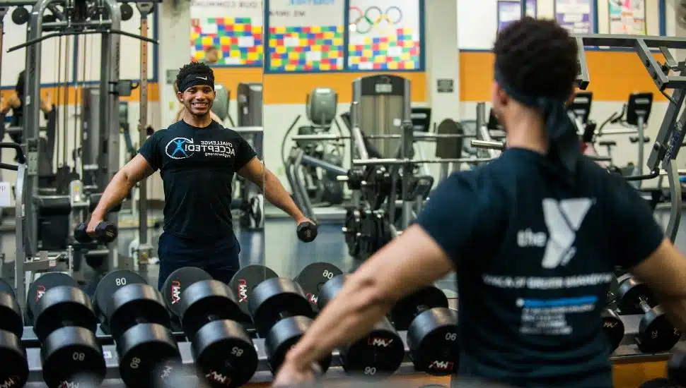 person at gym lifting weights