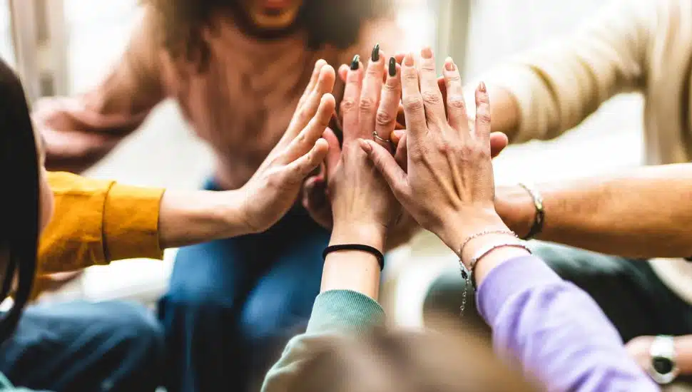 people high-fiving in group