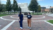 Students Marlaina Pappero and Emma Castellano chat on campus. Image via Widener University.