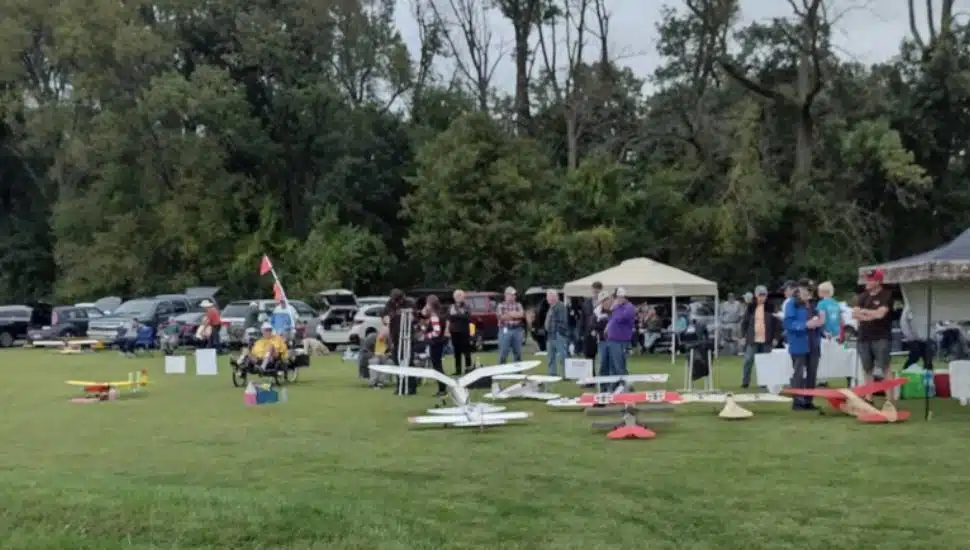 people with their vintage model airplanes