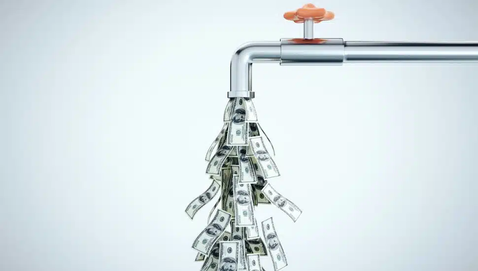 dollar bills coming out of water tap