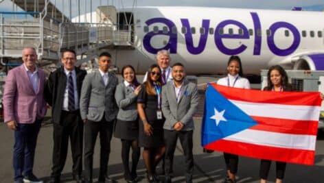 people in front of Avelo Airlines plane