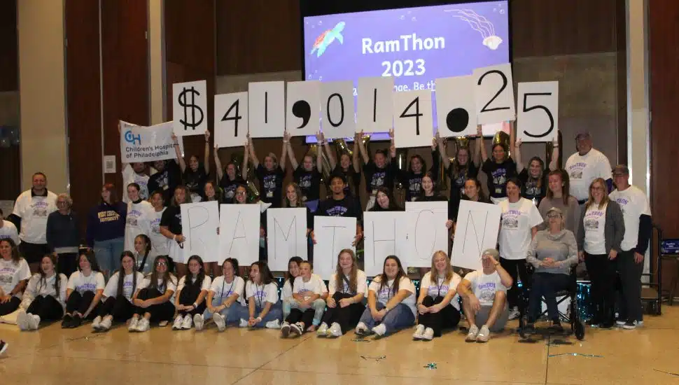 students holding up CHOP donation amount