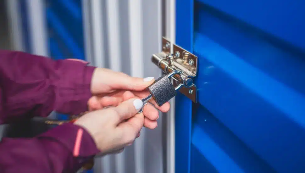 person locking self-storage unit