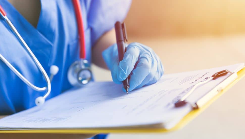 nursing student with clipboard
