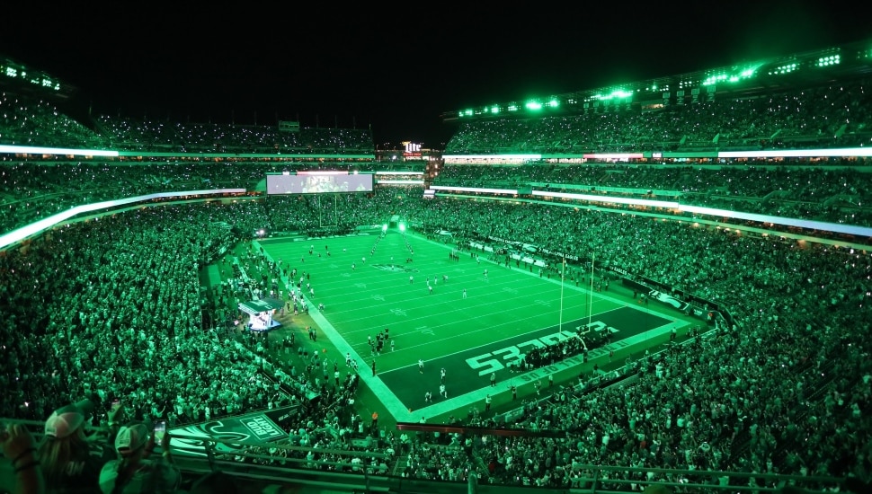 eagles fans in green-lit stadium