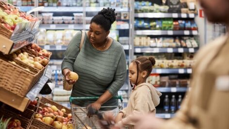 mother and daughter shop for groceries