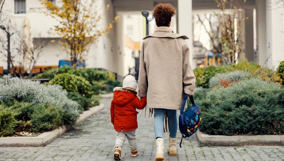 woman walking with her small child