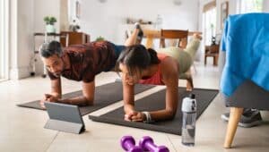 couple doing yoga/ home workouts