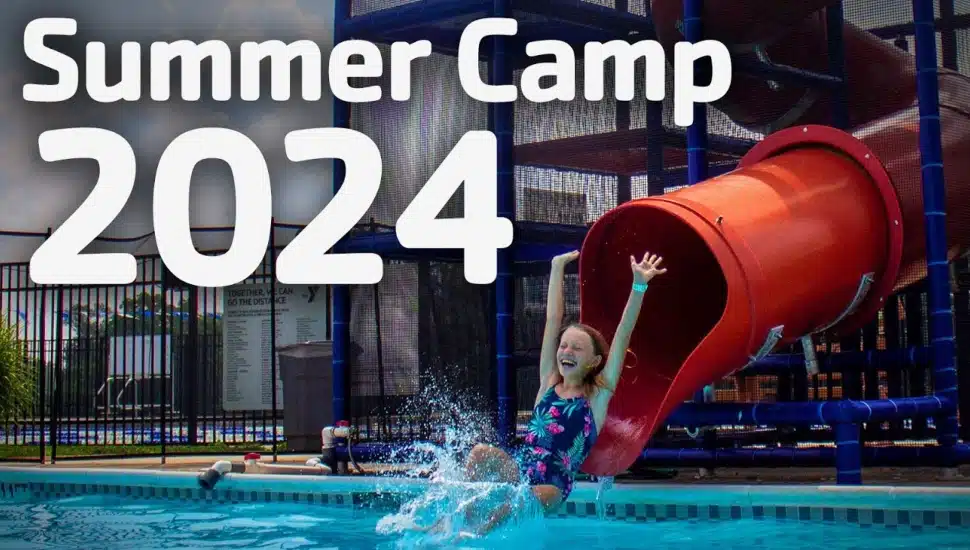 child on water slide at summer camp