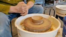 throwing clay on a wheel