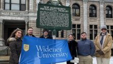 Widener University students stand in front of a New Hampshire Primary sign, proof that they got to experience the election first-hand.