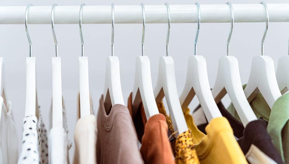 colored clothing hanging on clothing rack
