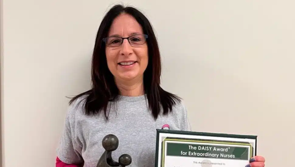 Michelle Lombardi holding award