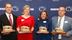 (Left to right) Stephen Bucci, Carolyn Hilder, Rachel Hurwitz-Casey and Brian Donoghue holding the Nittany Lion shrines they received as gifts for being inducted into the Athletics Hall of Fame.