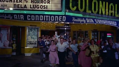 bunch of people running out of theater 1958