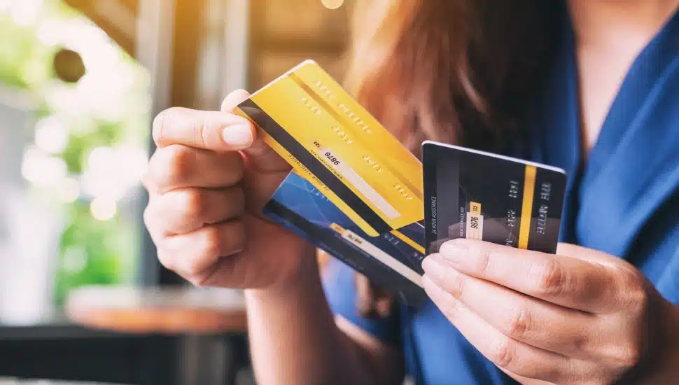 Closeup image of a woman holding and choosing credit card to use