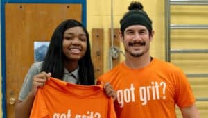 two people wearing orange "got grit?" shirts