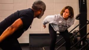 Bertram Lawson with woman fitness at the gym