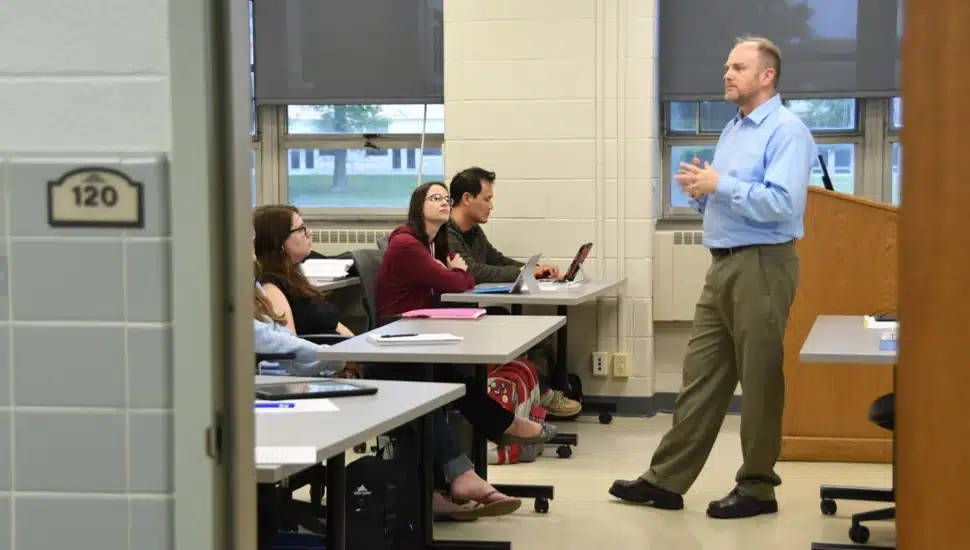students in classroom with professor.
