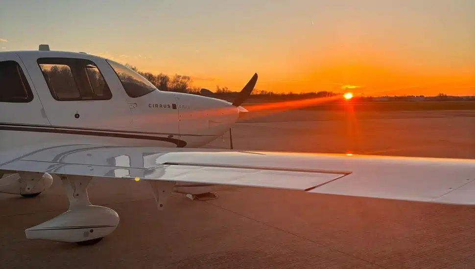 airplane grounded facing sunset
