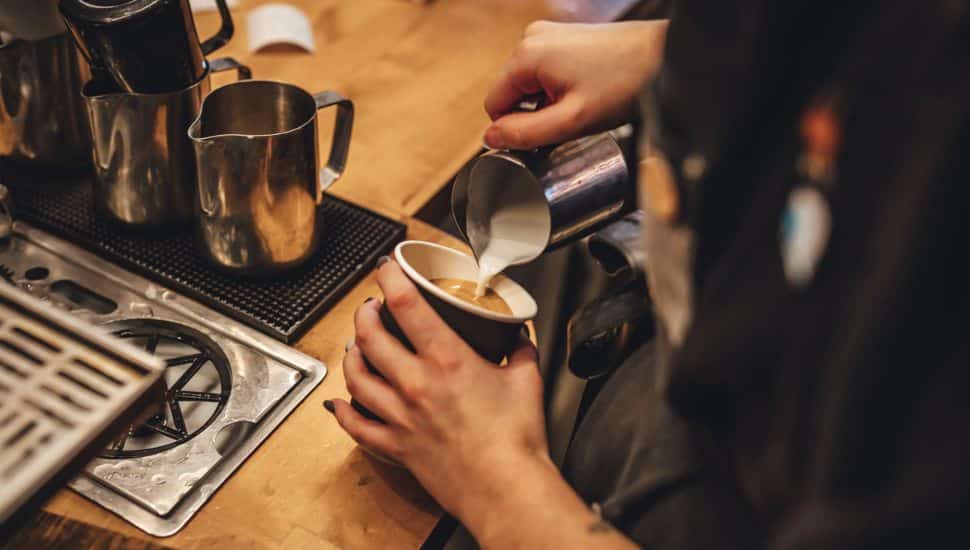 barista pouring coffee