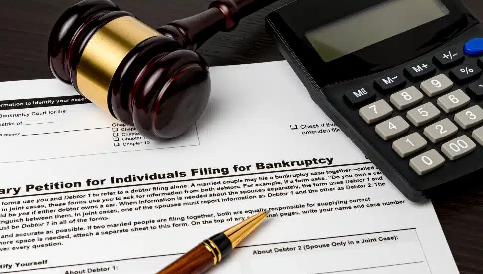 chapter 11 bankruptcy papers. calculator and gavel with pen