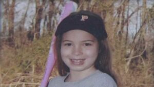 Kayden Mancuso in baseball hat holding pink bat