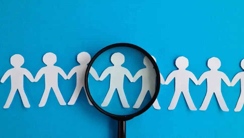 magnifying glass over people to indicate the "job search."