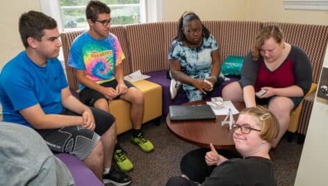 The mission of the Dub-C Autism Program (D-CAP) at West Chester University is to build an inclusive and accepting campus community to better support the experience and success of degree-seeking students with Autism Spectrum Disorder through indirect and direct supports. The following students in WCU’s Dub-C Autism Program (D-CAP) are pictured studying together in a sensory-friendly environment on campus: (L to R) Jason Kosmin, Victor Sereni, Ania Hawkins-Williams, Melanie Schwartz, Emma Billingsley.