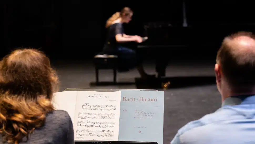young girl playing piano.