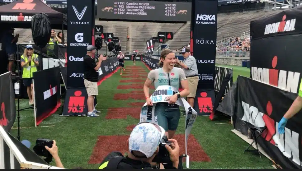 Caroline Moyer crossing the finish line