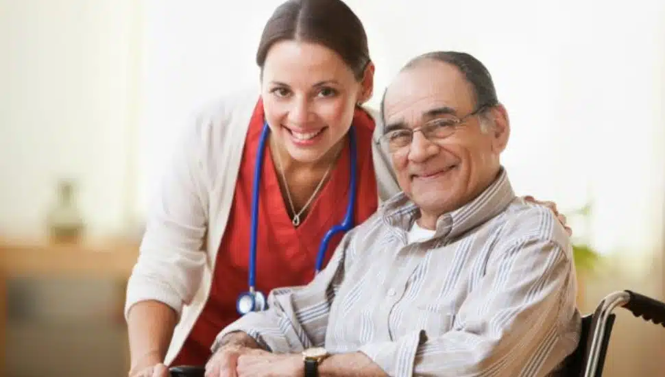 A nursing attendant poses for a photo with a resident of Freedom Village at Brandywine .