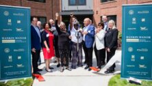 project contributors and residents join in the ribbon-cutting ceremony for Hankin Manor