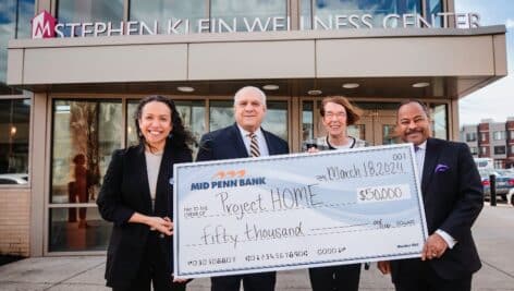 Dr. Nayeli Spahr of Project HOME, Ray Mincarelli of Mid Penn Bank, Sister Mary Scullion of Project HOME, and Brian Hudson, Mid Penn Board Member, present donation check on March 19, 2024.