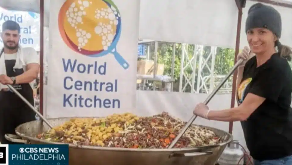 Olga Sorzano stirs big bowl of food