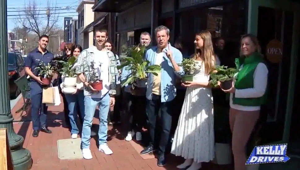 group of people outside the green house