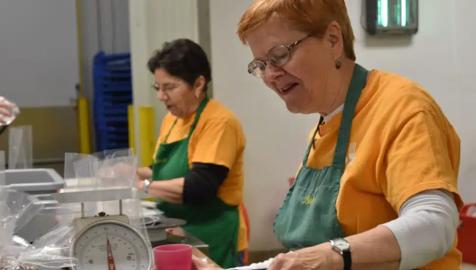A volunteer helping package food for community members.