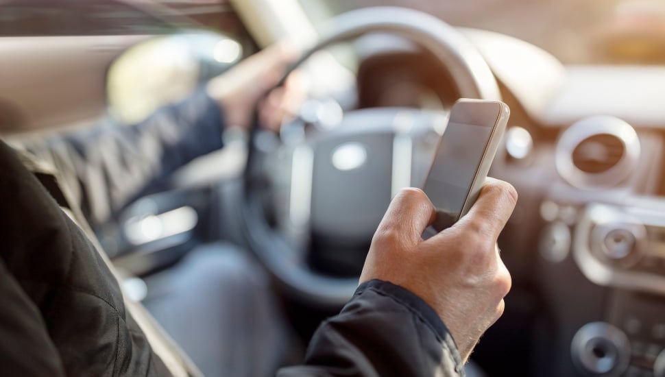 person texting and driving