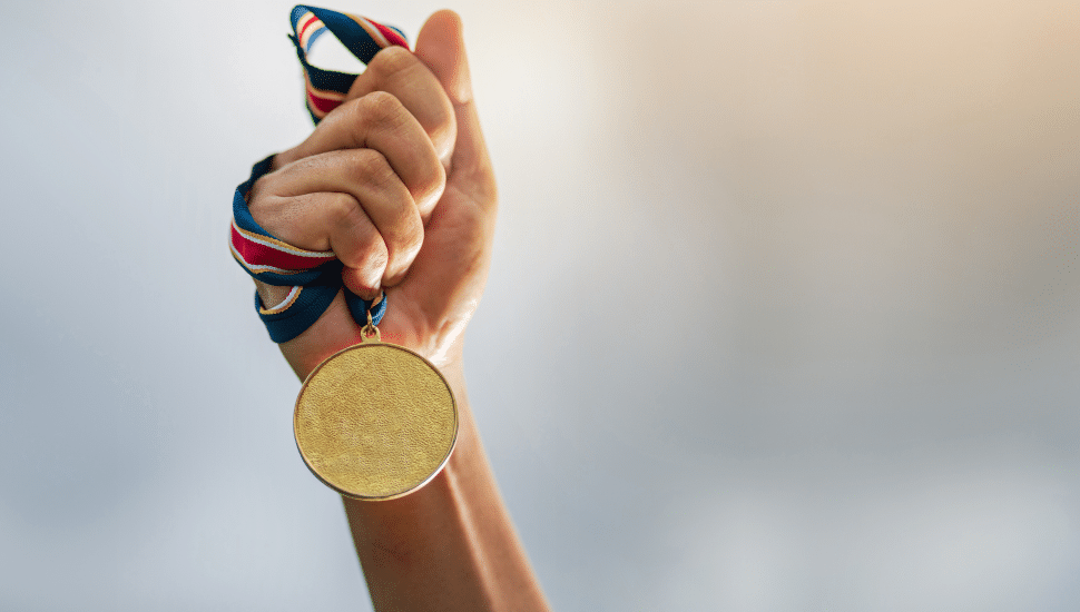 person holding gold medal