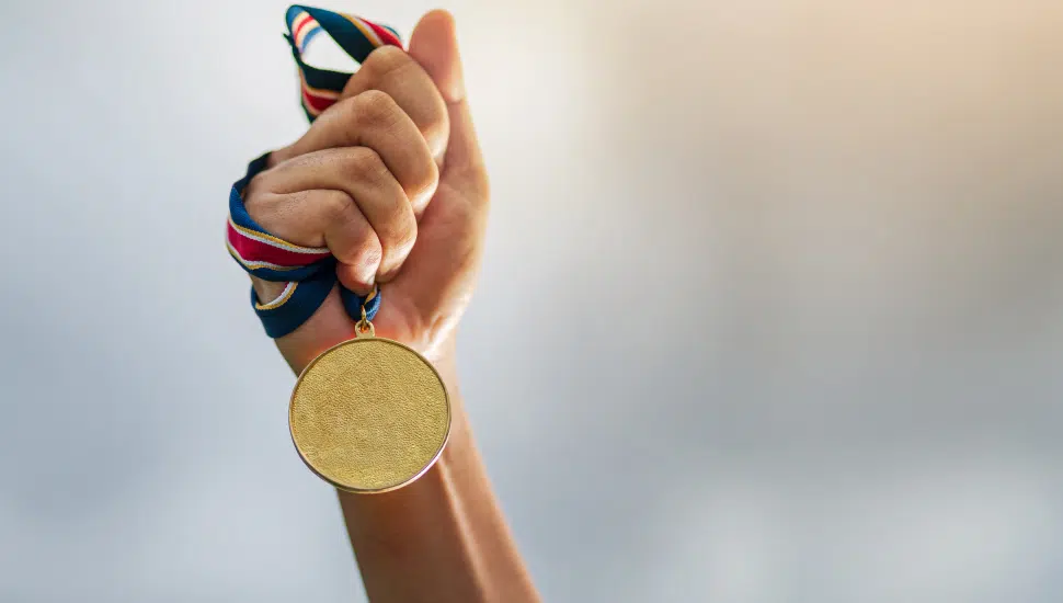 person holding gold medal