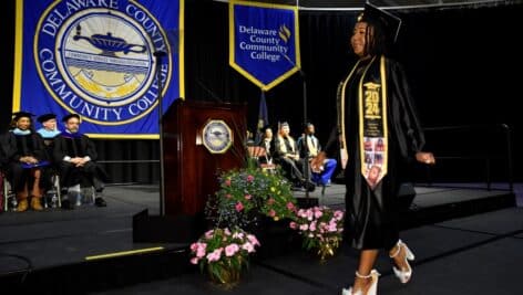 A Nursing graduate crosses the stage at DCCC’s Commencement.