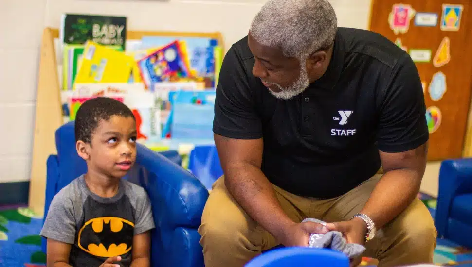 President & CEO, Bertram L. Lawson II speaks with a student at the Oscar Lasko YMCA.