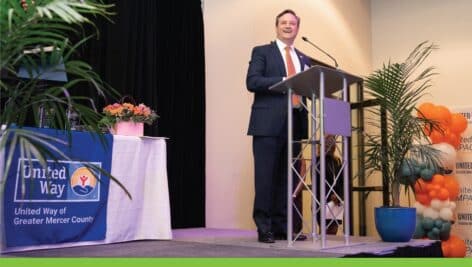 Patrick Ryan standing on stage after receiving the Live United Corporate Award by the United Way of Greater Mercer County.