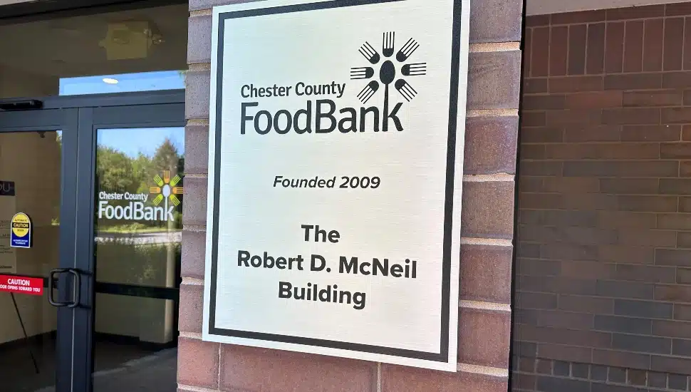 A photo of the plaque on the Chester County Food Bank building, commemorating the dedication to Robert D. McNeil.