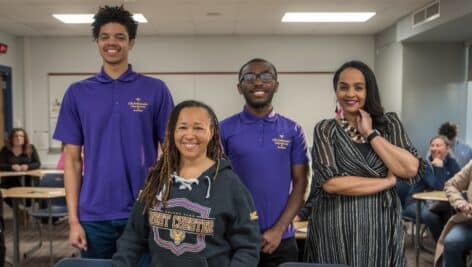 Dr. Desha Williams (center), dean of West Chester University’s College of Education and Social Work, is pictured at Plymouth Whitemarsh High School with recent WCU education graduates/former PRIZE Ambassadors Devin Davis (back row/left), Imere Williams (back row/middle), and Equity and Advancement Officer for Colonial School District Melissa Figueroa-Douglas (back row/right).