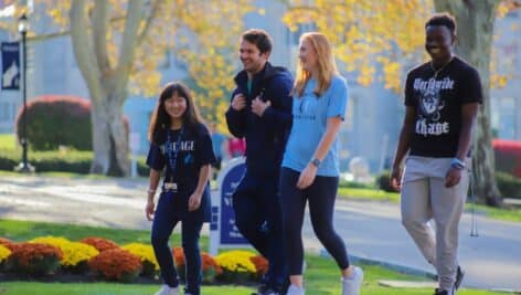 Group of undergraduate students walking on Immaculata U.'s campus.