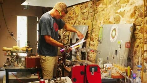 man doing glassblowing