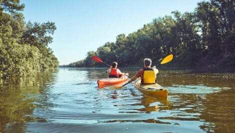 people kayaking down river